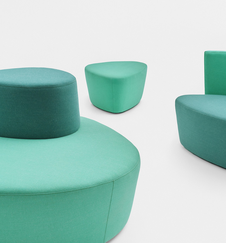 Modular breakout seating in various shapes and shades of green on a white background