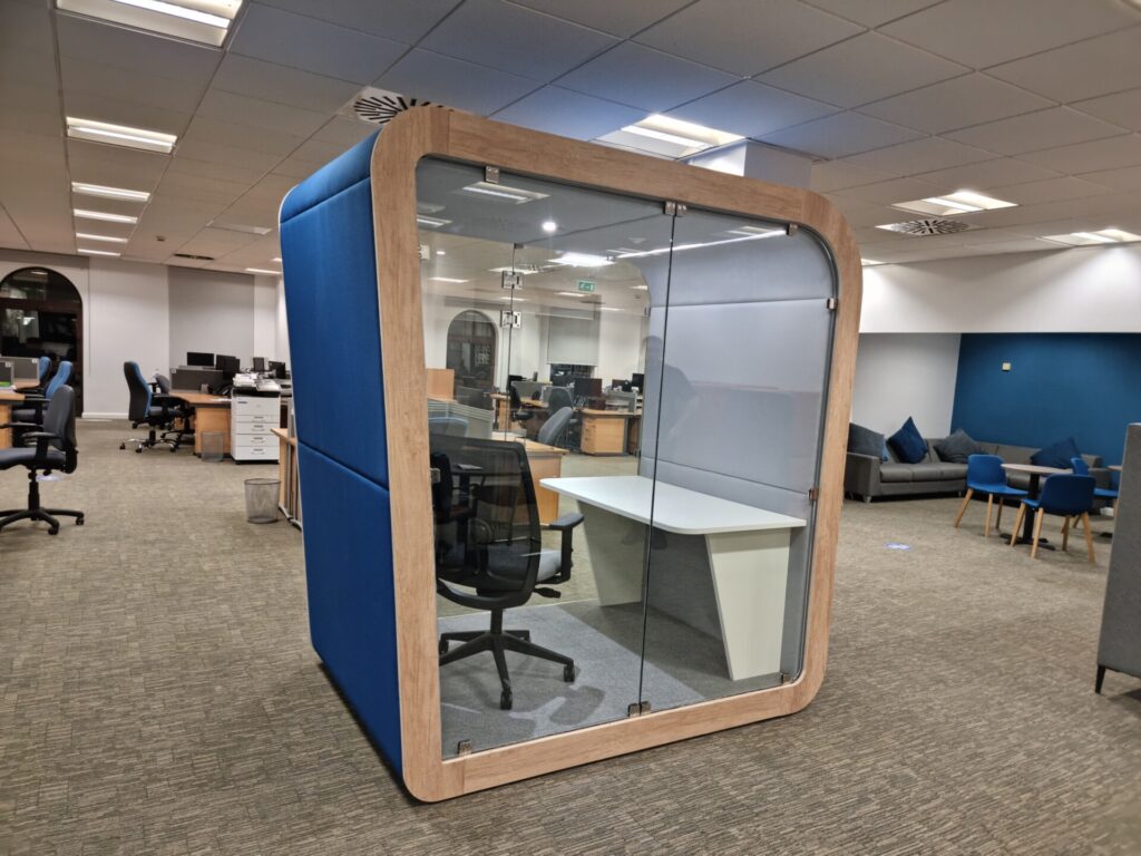 Thinkpod acoustic phone booth with desk and chair in an open-plan office