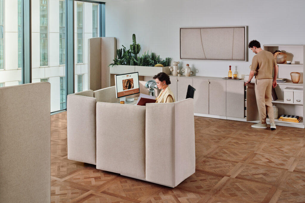 Soma modular breakout seating in an office environment with two workers