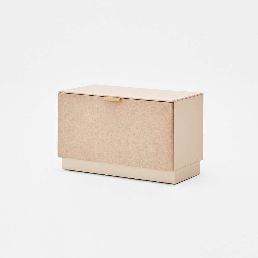 Soma storage cabinet with fabric-covered front and gold-colored handle