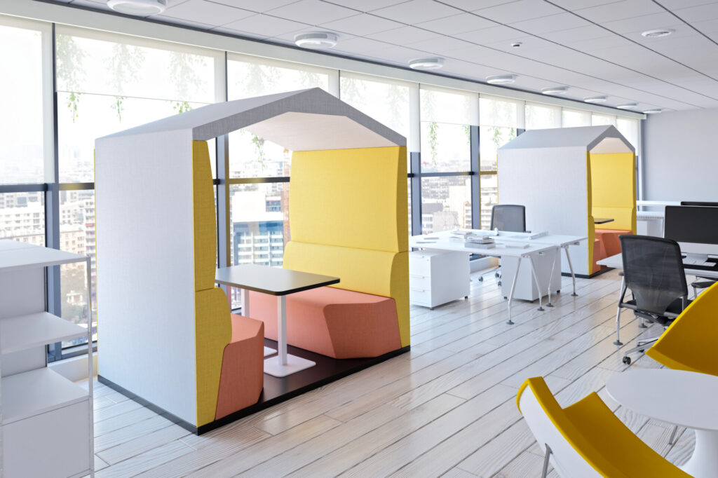 Thinkpod acoustic office pods with integrated seating and tables in a modern office