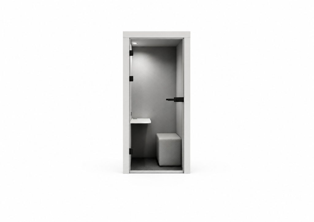 Acoustic phone booth with light grey interior, small white shelf, and grey upholstered stool