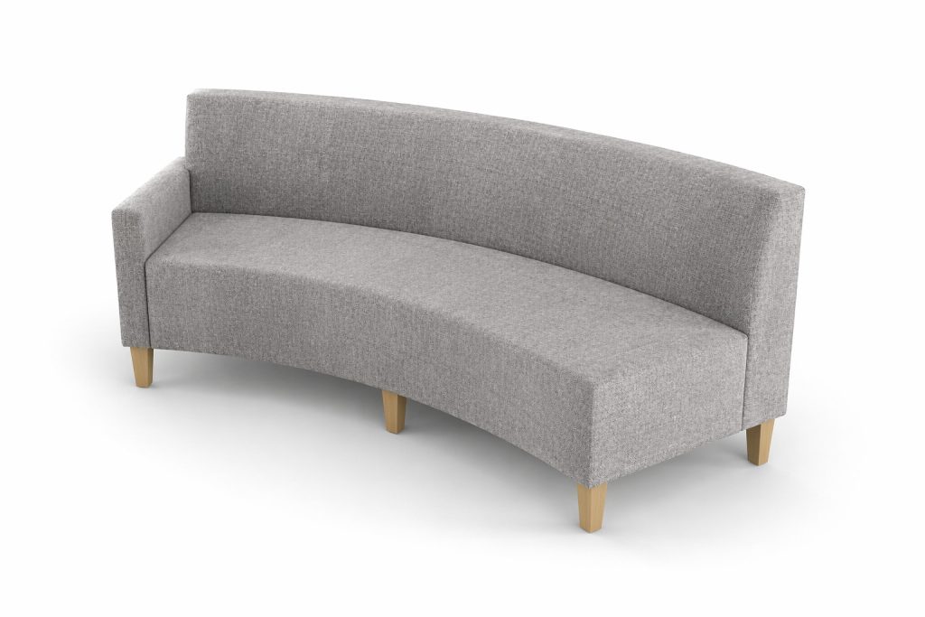 Curved modular breakout seating unit with a high back and wooden legs, suitable for reception or education spaces.
