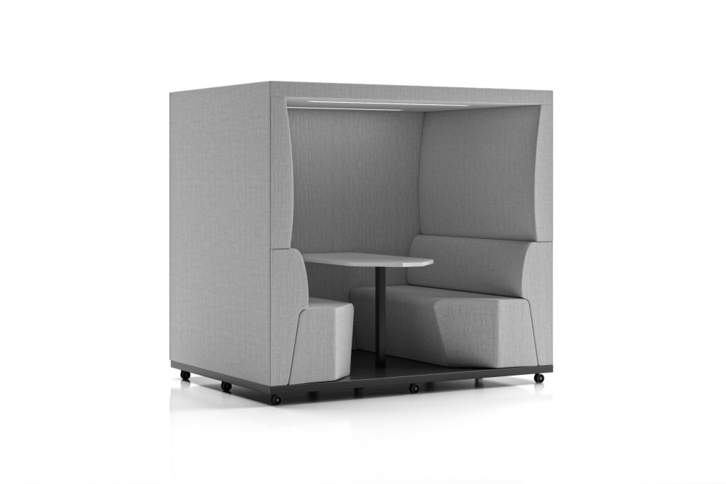 Acoustic office pod with light grey fabric, internal seating, and a small table.